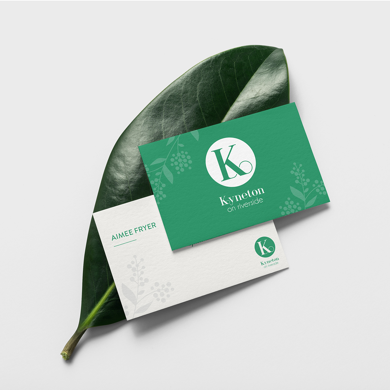 Kyneton on Riverside business cards laid on a green leaf